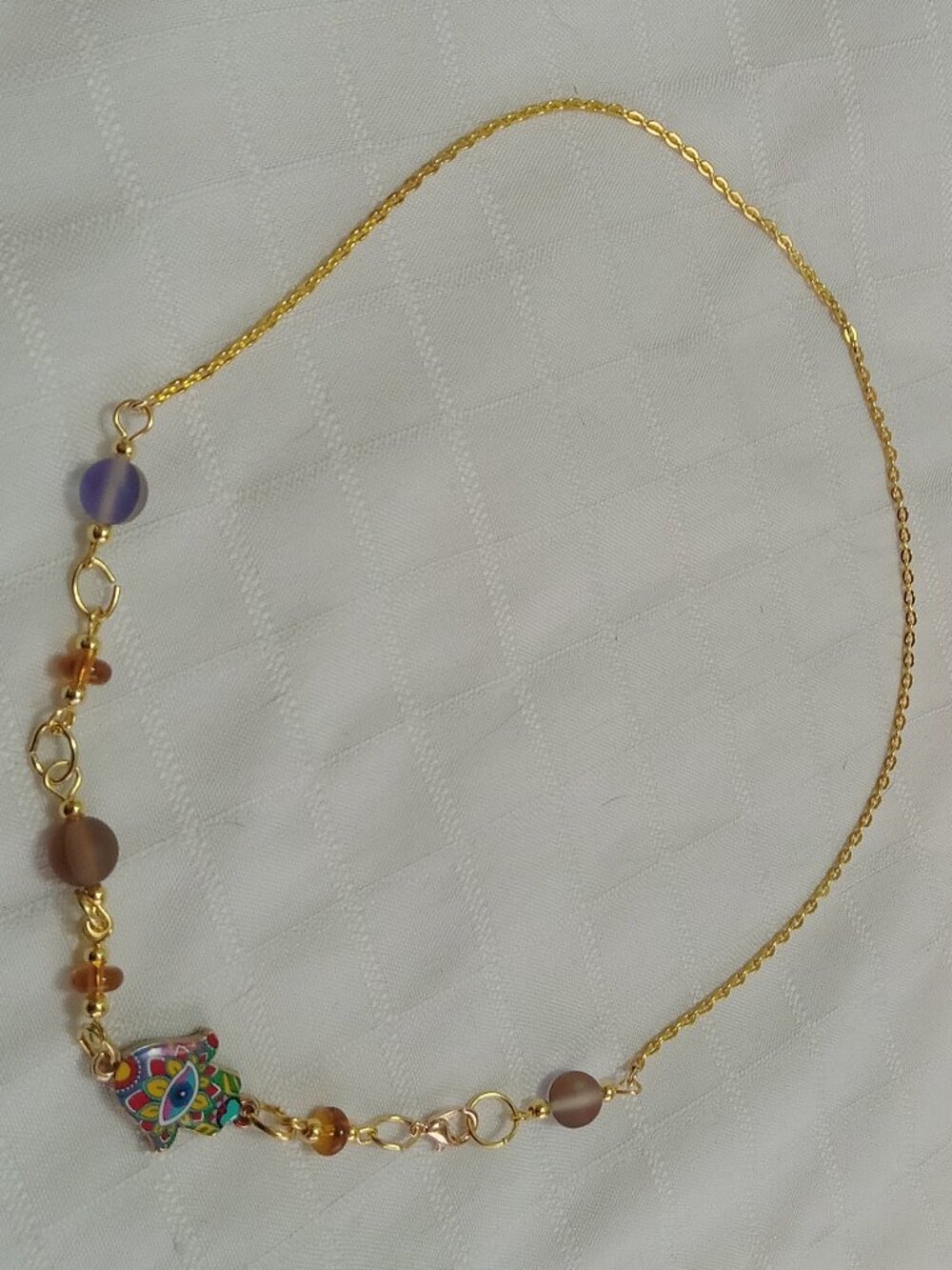 A pretty, minimalist, asymmetrical, reversible handmade necklace